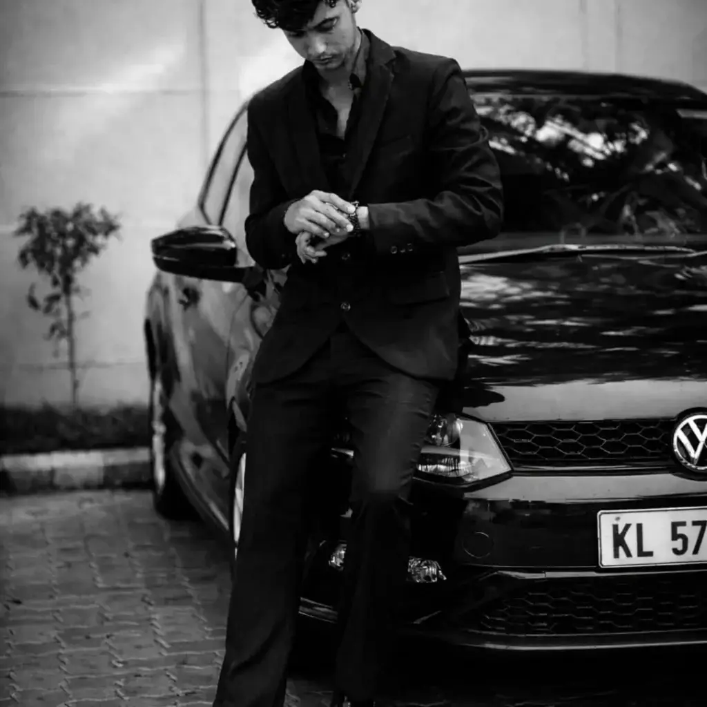 A digital marketer standing next to a car.