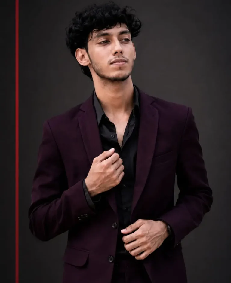 Faseeh ahamed ismail a digital marketing strategist in calicut, posing in a dark suit for his digital marketing portfolio